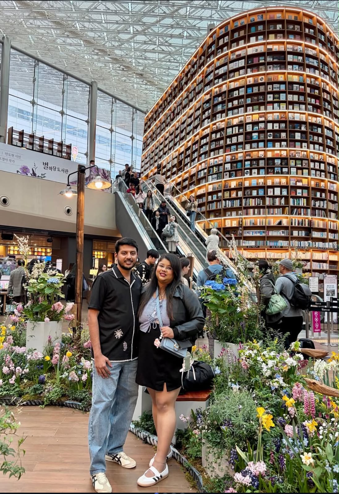Travelers exploring a flower-filled city space