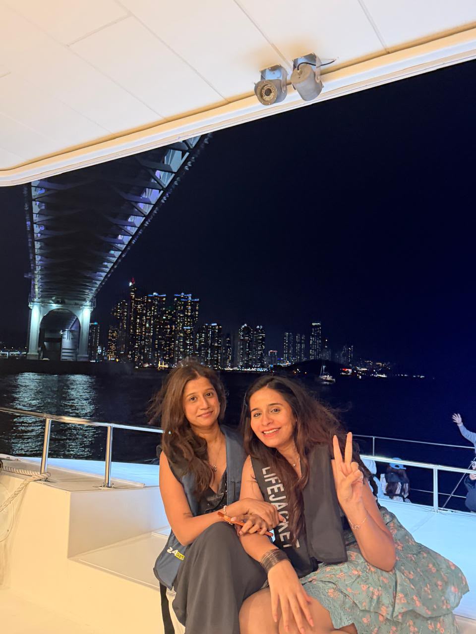 Friends enjoying city lights from a boat